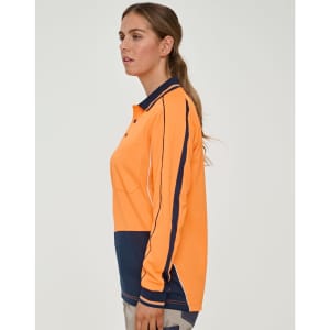 A woman models a bright orange long-sleeve polo shirt with navy accents and a logo.