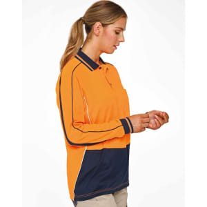 A woman wearing a hi-vis long-sleeve polo in orange and navy, featuring a logo and contrasting panels.
