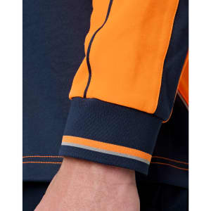 A close-up of a navy and orange long-sleeve polo featuring contrasting stripes at the cuffs. The image includes branding.
