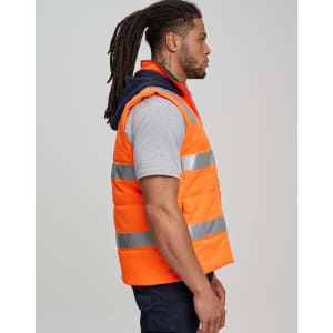 Unisex hi vis hooded puffer vest in bright orange with reflective strips, worn by a model in profile view.