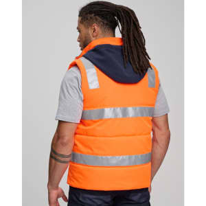 A unisex hi vis hooded puffer vest in orange with reflective stripes, featuring a navy hood and a logo.