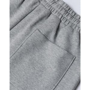 A close-up of grey unisex sweatpants featuring an elastic waistband and a back pocket.