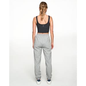 A person wearing grey unisex airlayered CVC sweatpants from a rear view, paired with a dark crop top.