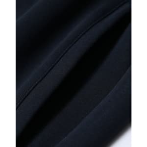 A close-up of navy unisex airlayered CVC sweatpants showing fabric texture and seams. Includes branding.