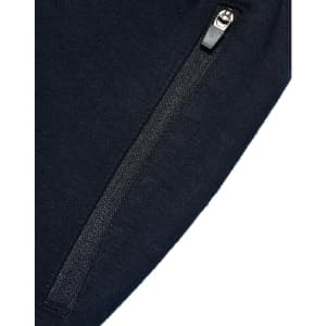 A close-up of navy kids' poly/cotton terry sweat pants featuring a zippered pocket and a smooth fabric texture.