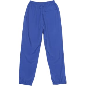 Track pants in a vibrant blue colour with an elastic waistband and a single back pocket. Features branding on the fabric.