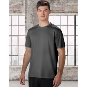 A men's short sleeve tee in grey, featuring a minimal design and a logo. The model stands against a large window background.
