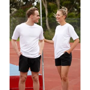 A white unisex short sleeve tee is displayed on a male and female model, set against an outdoor sports background.