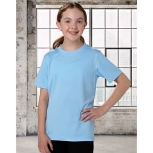 A child in a light blue short sleeve tee, smiling with hands on hips, against a backdrop of large windows.
