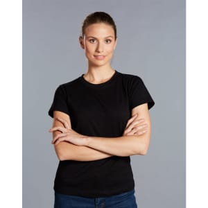 A black cotton semi-fitted tee on a model with arms crossed, against a grey background. The shirt has a logo.
