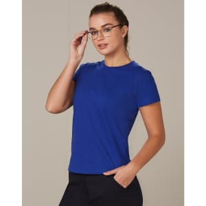 A blue semi-fitted cotton tee with short sleeves, displayed on a model wearing glasses. The tee features a logo.