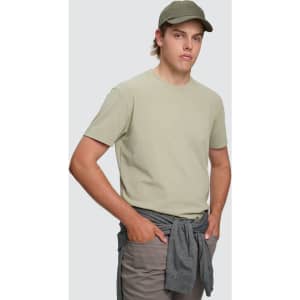 A light green men's premium cotton short sleeve tee shirt displayed on a model with a cap and grey shorts.