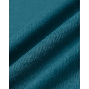 A close-up of teal premium cotton fabric with a soft texture, featuring folds and a smooth finish.