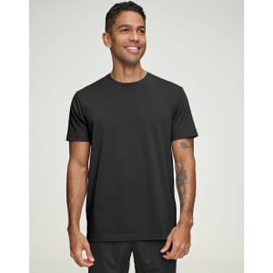 A men's premium cotton short sleeve tee shirt in black, featuring a logo on the chest, worn by a smiling model.