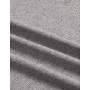A close-up of a grey premium cotton T-shirt fabric, featuring a soft, textured finish and gentle folds.