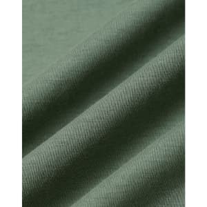 A close-up of folded fabric in a soft, muted green colour, showcasing a smooth texture with subtle ribbing.