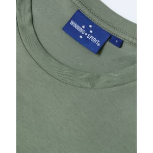A green premium cotton short-sleeve T-shirt featuring a crew neckline and a logo label on the inside.