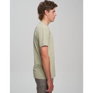 A light green men's premium cotton short-sleeve t-shirt displayed on a model from the side. The shirt has a logo.