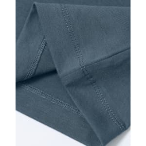 A close-up of a men's premium cotton t-shirt in a muted blue colour, showcasing stitching details and fabric texture.
