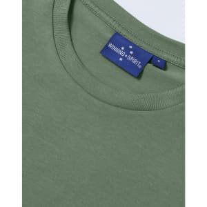 A green premium cotton ladies' short sleeve t-shirt with a label on the neckline.
