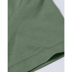 A close-up of a ladies' premium cotton short sleeve tee shirt in a muted green colour, featuring a logo.