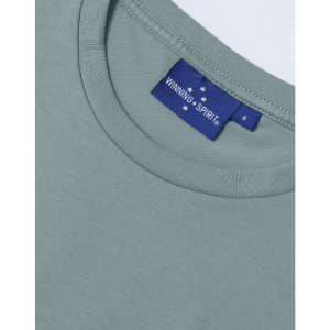 A light green ladies' premium cotton short-sleeve tee shirt featuring a label with a logo.