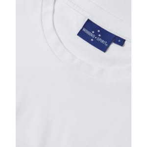 A white premium cotton short-sleeve tee shirt with a branded tag.