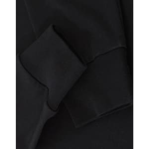 A black long-sleeve tee shirt with a close-up of the sleeve and cuff detailing. It features a logo.