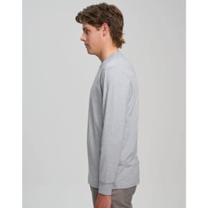 A grey long-sleeve T-shirt displayed on a model from the side, featuring a simple design and a logo.