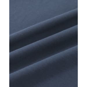 A close-up of soft, dark navy cotton fabric with smooth folds, showing its texture and quality.