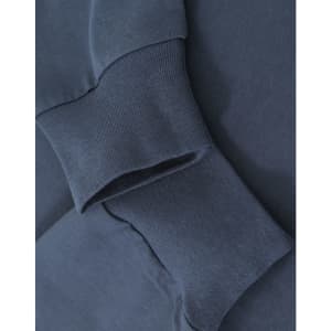 A close-up of navy blue cotton tee shirt cuffs with ribbed detailing, featuring a logo on the fabric.