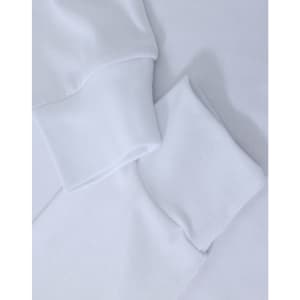 A white long-sleeve tee shirt with cuff details, featuring a subtle logo.