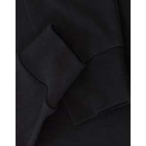 A close-up of black long-sleeve cotton tee shirt cuffs, featuring a visible logo.