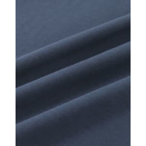 A close-up of dark navy blue cotton fabric, showcasing its smooth texture and folds.