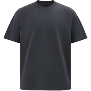A black unisex heavy cotton oversized tee featuring a simple design and a round neckline. It has a logo on it.