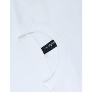 A white unisex heavy cotton oversized tee featuring a rounded neckline and a tag on the inside.