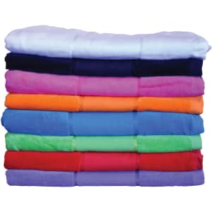 A stack of terry velour beach towels in various vibrant colours, featuring a range of shades from white to dark blue.