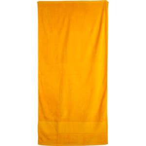 A bright yellow terry velour beach towel measuring 75x150 cm, featuring a textured surface and a solid design.