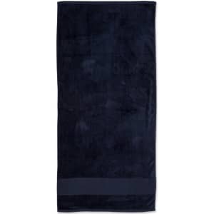 A dark navy terry velour beach towel measuring 75x150 cm, featuring a simple design and a branded logo.