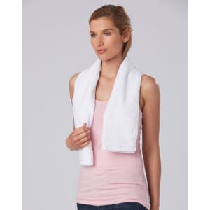 A white terry velour fitness towel draped over a woman's shoulders, featuring a logo.