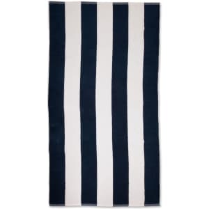 A striped beach towel featuring alternating navy blue and white stripes, with a logo at one corner.