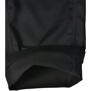 A pair of black cargo pants showcasing a folded cuff, featuring a durable fabric and a branded label.