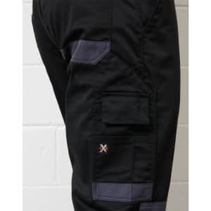 A close-up of black cargo pants featuring grey accents and a logo on the side.