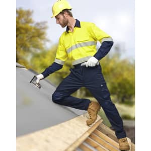 A safety shirt in bright yellow and navy, featuring segmented reflective tape, worn by a man on a roof.