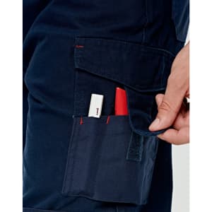 A pair of navy work pants with pockets, featuring red stitching and a hand reaching into a side pocket.