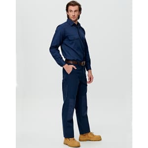 A man poses wearing dark blue heavy duck weave work pants with pockets, complemented by a matching shirt and boots.