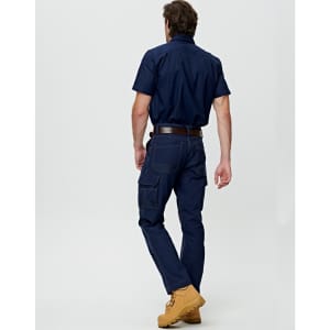A man wearing navy lightweight semi-fitted Cordura work pants, paired with a navy shirt and brown work boots.