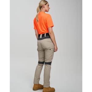 Work pants in beige with navy accents, paired with an orange shirt, displayed from the back. Features a logo.