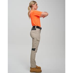 Work pants in beige with black accents, styled on a model wearing an orange top, showcasing a side view.