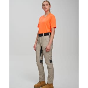 A model wearing orange workwear shirt and beige rip-stop poly/cotton stretch work pants with black detailing.